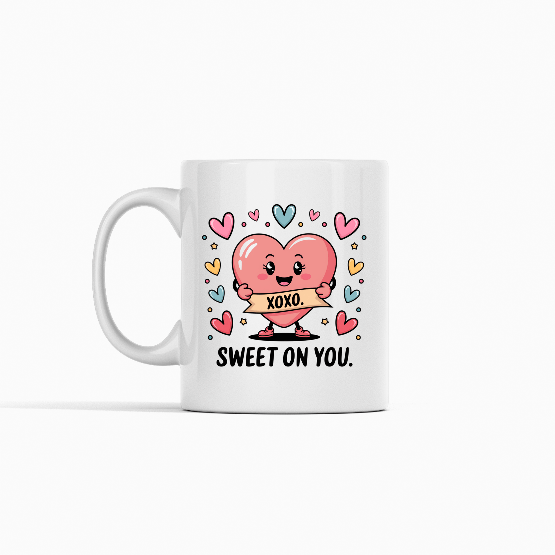 The Sweet On You Heart Mug by Mirabilia Boutique features a cute pink heart holding an "XOXO" sign, colorful hearts, and "SWEET ON YOU." text—an adorable Valentine's gift for someone special.