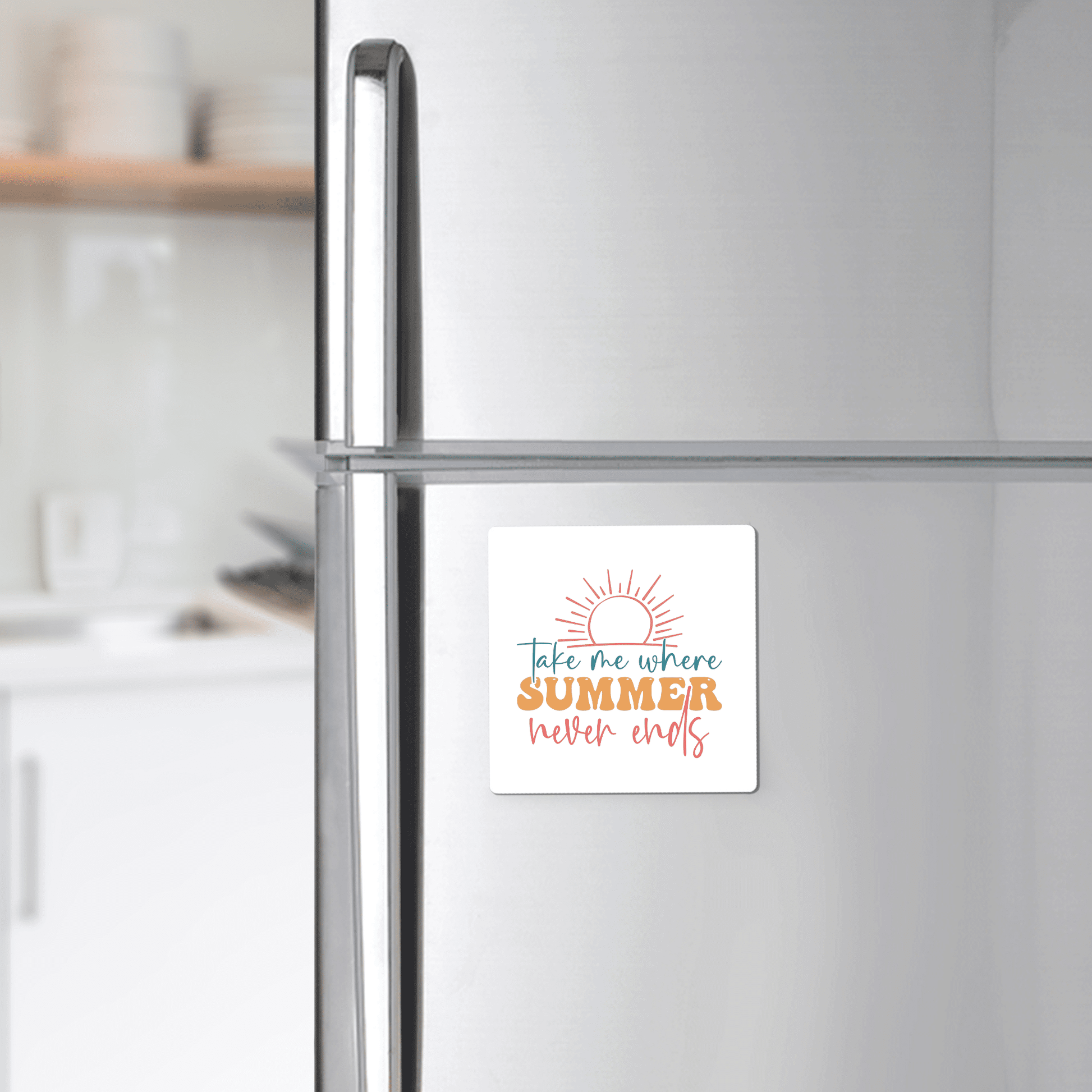 The Take Me Where Summer Never Ends Magnet by Mirabilia Boutique features a sun above vibrant text on a square magnet, perfect for your fridge décor or as a beach lover gift. Blurred kitchen counter and shelves appear in the background.