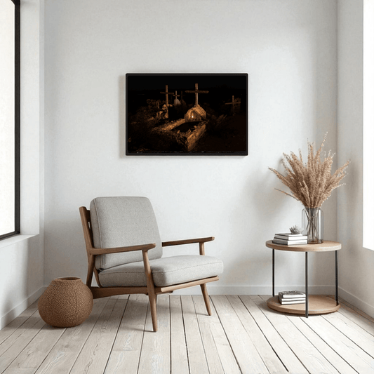 A cozy modern living room featuring a light armchair, a round side table with dried grass decor, and the “Terlingua Cemetery at Night” framed fine art print by Mirabilia Boutique displayed on the wall—this striking artwork showcases West Texas photography with a dark, moody graveyard scene inspired by the historic Terlingua Cemetery, complete with crosses and warm lighting.
