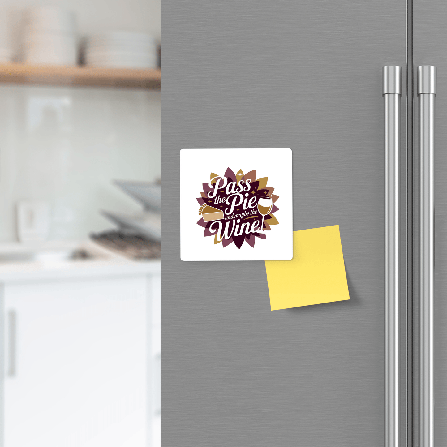 A Mirabilia Boutique "Pass the Pie & Wine Magnet" | Funny Thanksgiving Fridge Decor adds festive charm to a kitchen refrigerator, displayed with a blank yellow sticky note among shelves and holiday kitchen items.