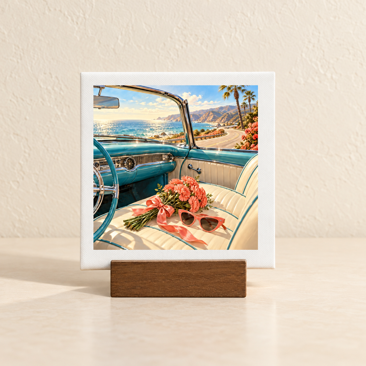 The Best Is Still Ahead Birthday Mini Sign, a square tabletop artwork in a wooden stand showing the interior of a vintage blue convertible parked by the ocean with a bouquet of pink flowers and sunglasses on the seat.