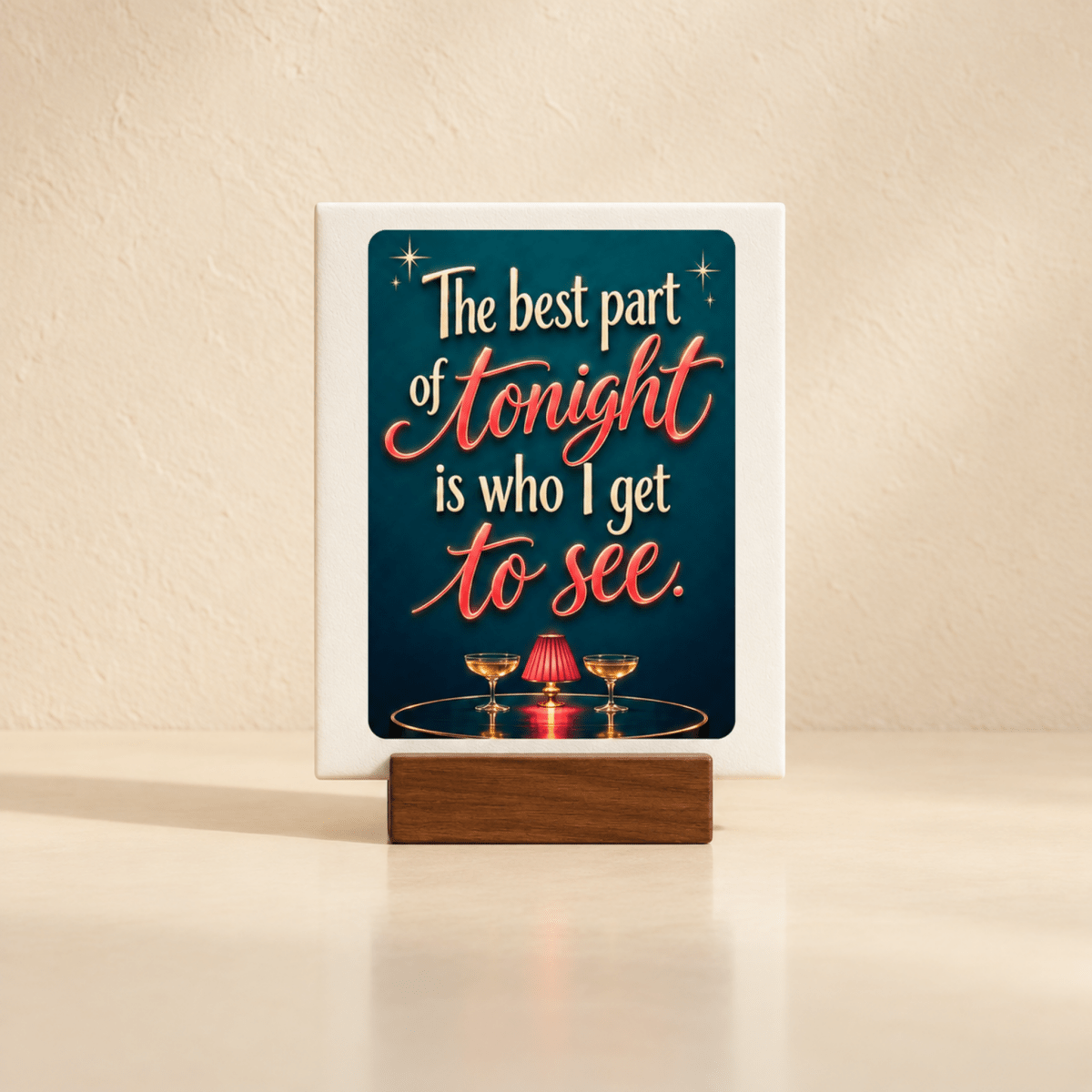 Add a charming touch to your table with the Mirabilia Boutique The Best Part of Tonight Mini Sign | Chrome & Starlight, featuring champagne glasses, a candle, and the heartwarming quote: “The best part of tonight is who I get to see.”.