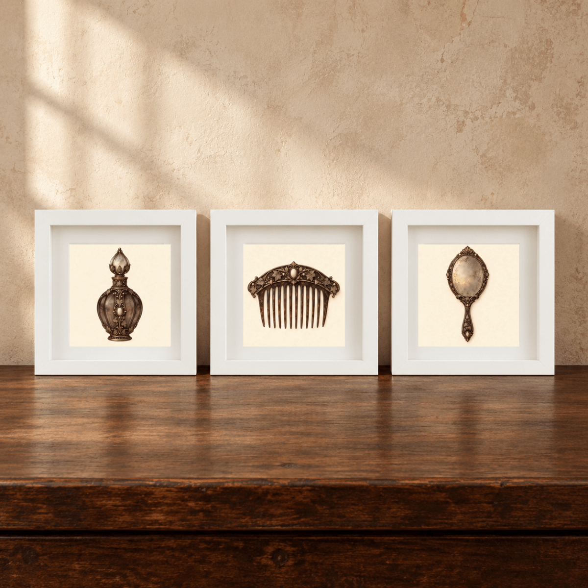 Three white-framed shadow box frames from Mirabilia Boutique’s “The Last Dressing Table | Mirabilia Relics” display a perfume bottle, an ornate hair comb, and a vintage handheld mirror on a wooden table against a beige textured wall—a sophisticated art set that brings timeless charm and elegance to your space.