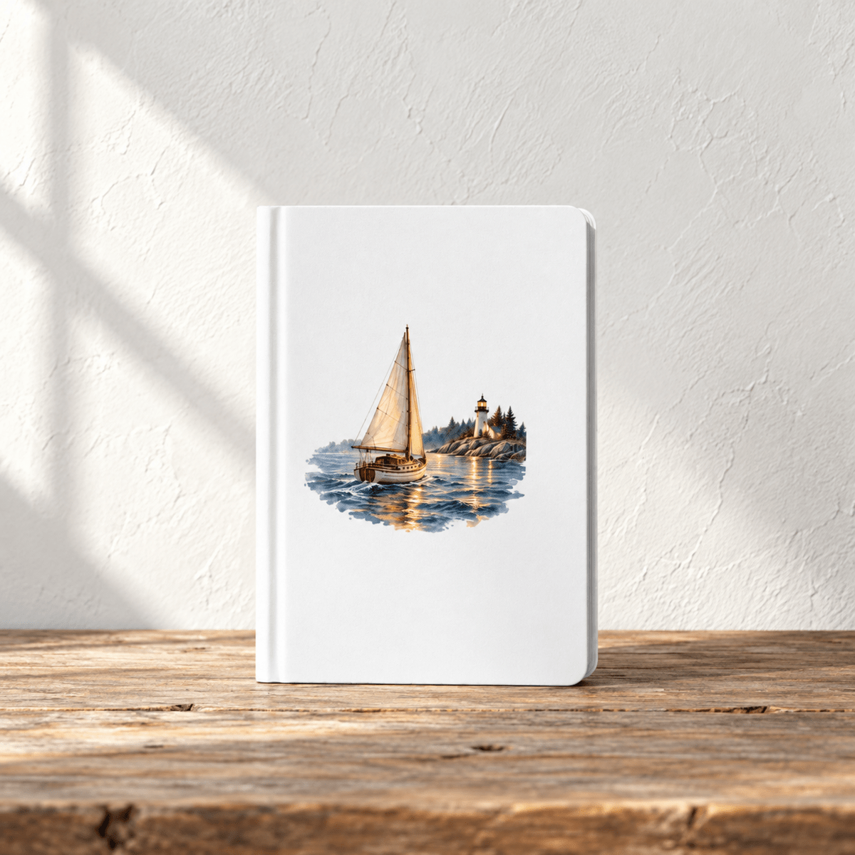 The Long Way Home A5 Journal by Mirabilia Boutique, featuring a watercolor illustration of a sailboat near a lighthouse on a rocky shore, resting on a rustic wooden table.