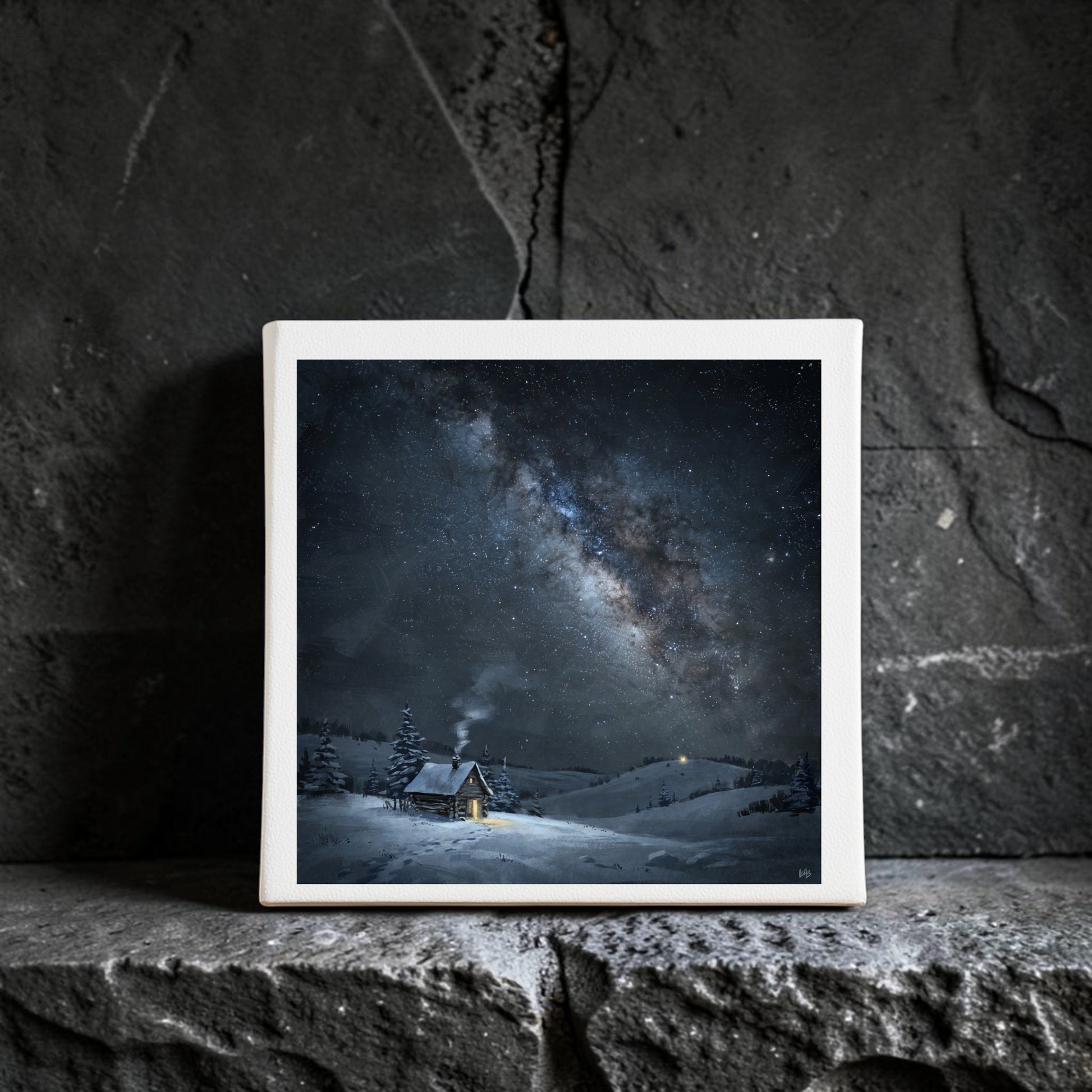A striking piece of winter night sky art, “The Night Is Listening Milky Way Canvas Art | 8x8” by Mirabilia Boutique, features a snowy cabin beneath a star-filled Milky Way and hangs beautifully on a dark stone wall.