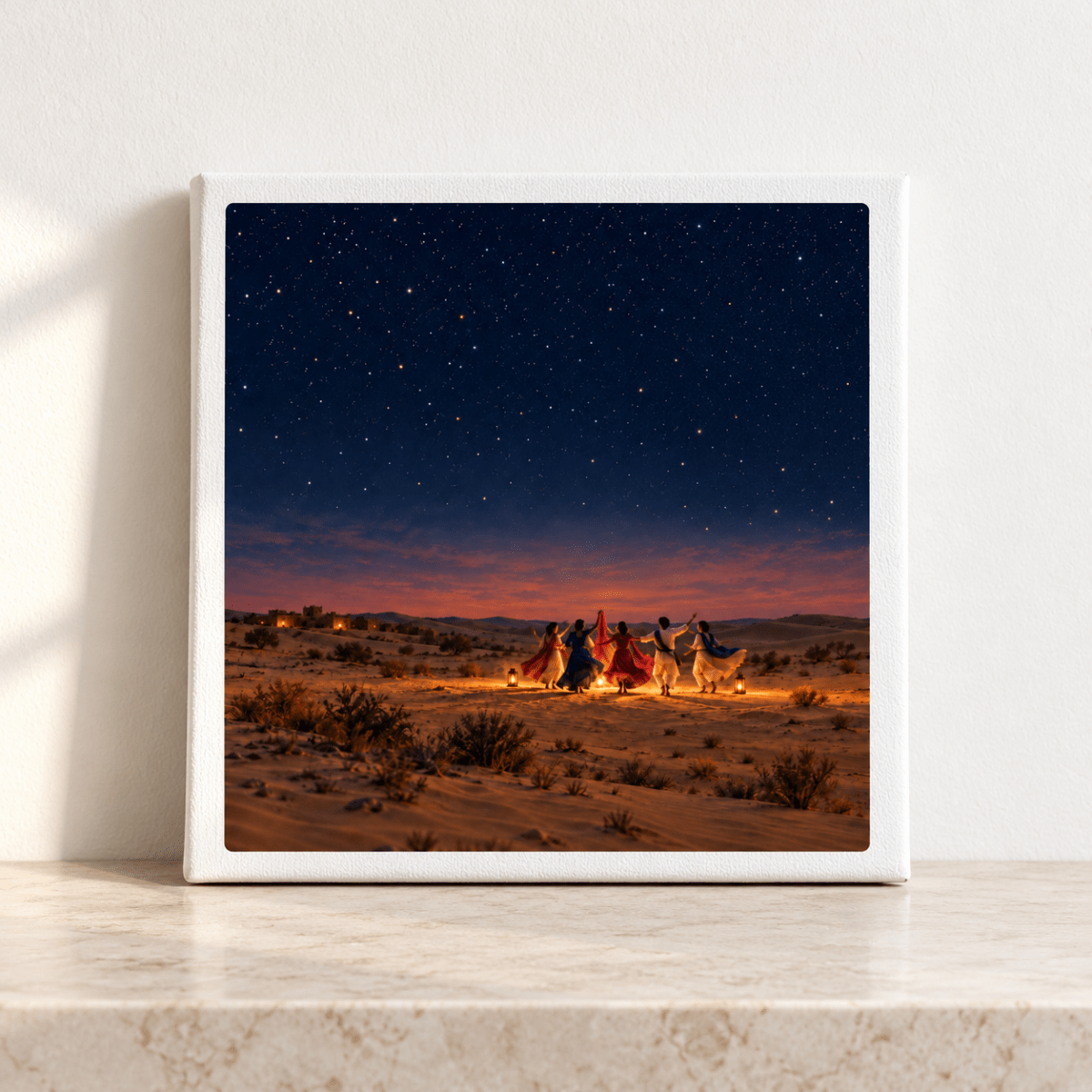 The Night We Danced Canvas | Sand & Saffron is a square gallery-wrapped print showing a group of people dancing in a circle in the desert under a starry night landscape.