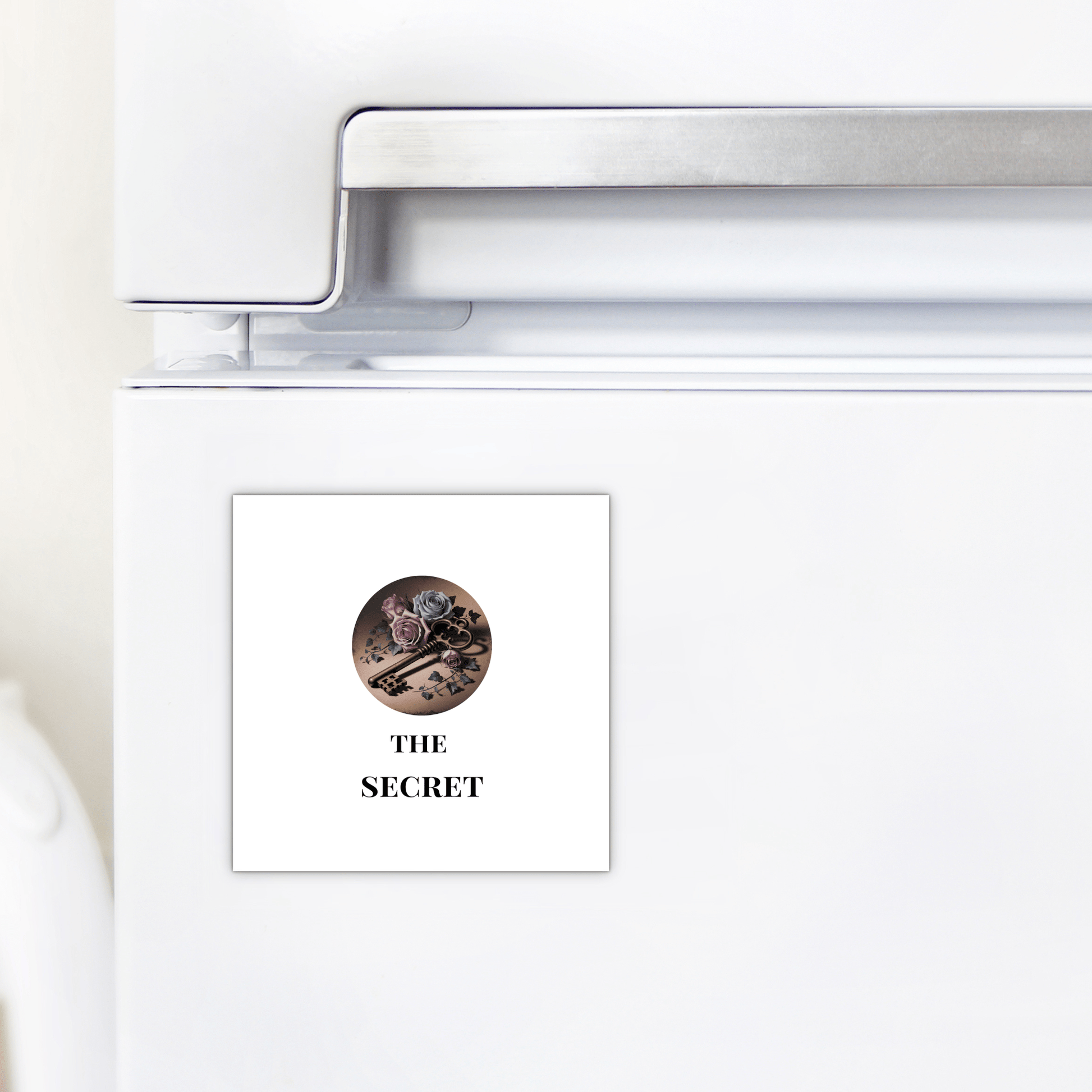 A white fridge displays Mirabilia Boutique’s "The Secret Magnet"—a gothic key art piece with chocolates, macarons, and berries. "THE SECRET" in bold black adds Dead Regency decor flair to your dark academia-inspired space.