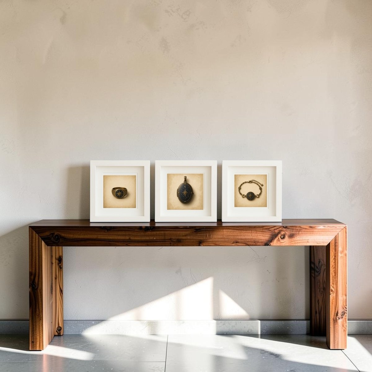 A wooden bench displays “The Wayfinder | Mirabilia Relics,” a collectible trio of framed canvas artworks from Mirabilia Boutique, each showcasing small vintage objects against a plain, light-colored wall. Sunlight filters in, casting gentle shadows on the bench and floor.