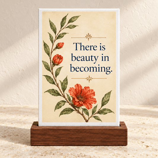 There Is Beauty in Becoming Mini Canvas Sign, a botanical artwork on a wooden base featuring orange flowers and the text, “There is beauty in becoming.”