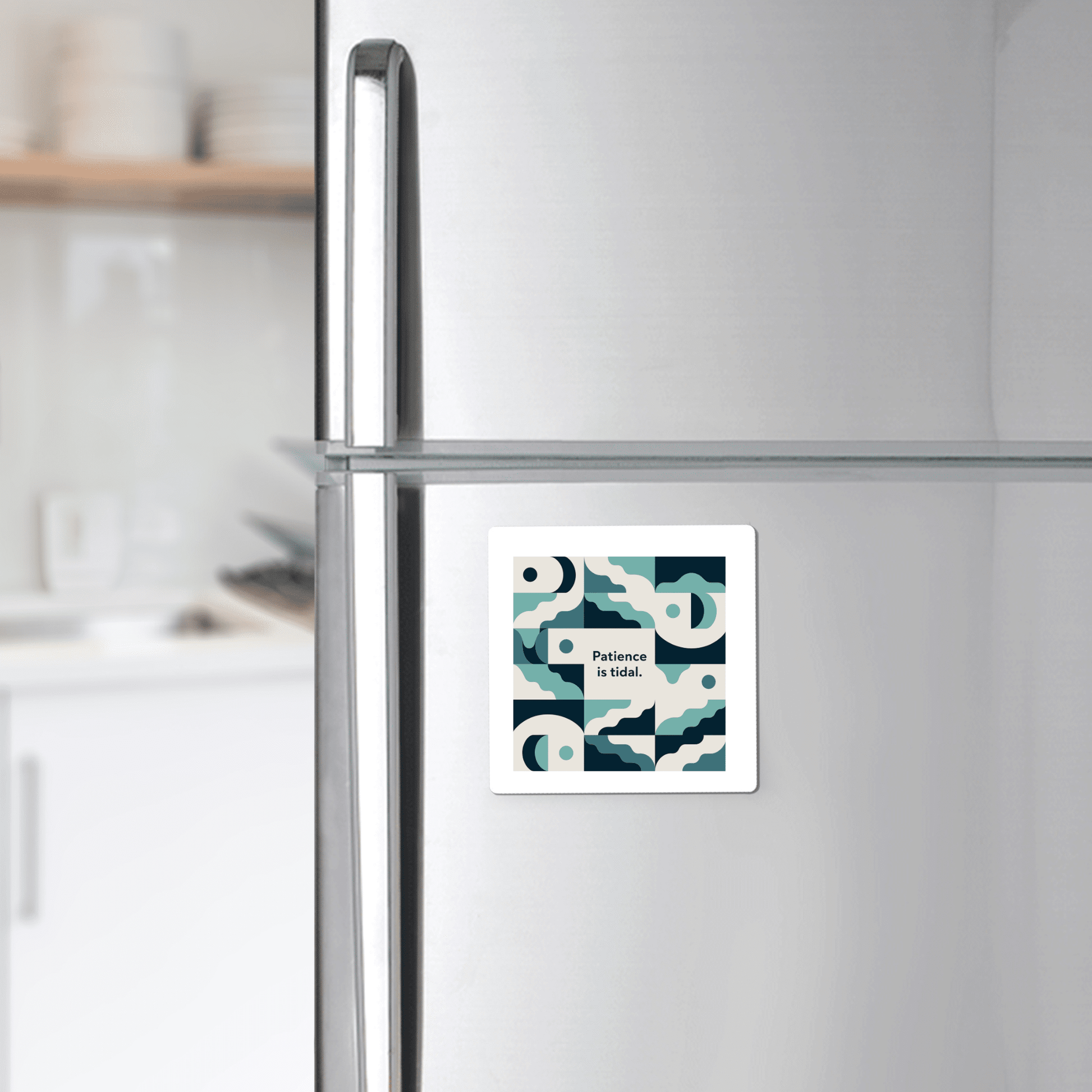 A modern kitchen features the Mirabilia Boutique Patience Is Tidal Magnet—an ocean-inspired calm quote with abstract shapes.