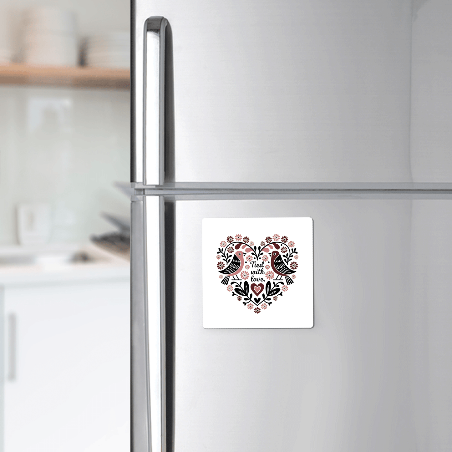 The Tied With Love Birds Magnet by Mirabilia Boutique features a heart-shaped floral design with two birds and "And then there was love" text—perfect as a charming love magnet or unique wedding favor.