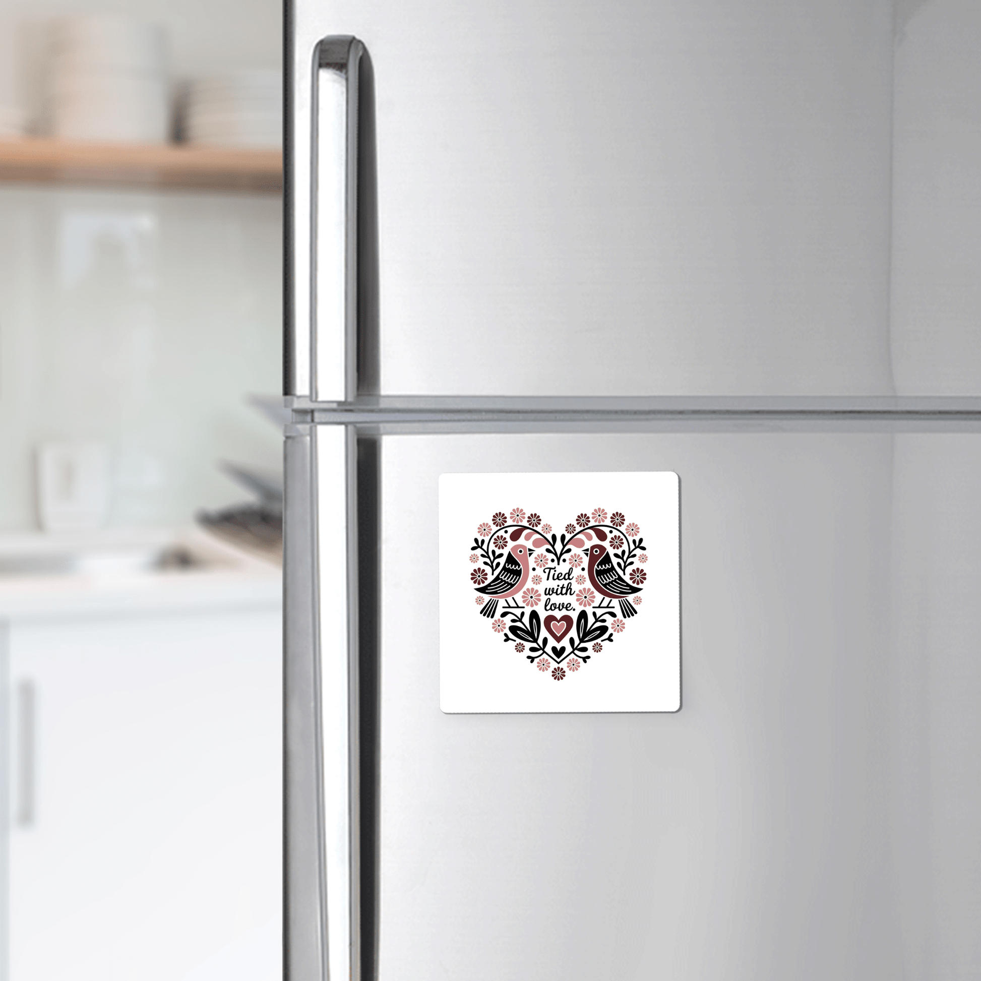 The Tied With Love Birds Magnet by Mirabilia Boutique features a heart-shaped floral design with two birds and "And then there was love" text—perfect as a charming love magnet or unique wedding favor.