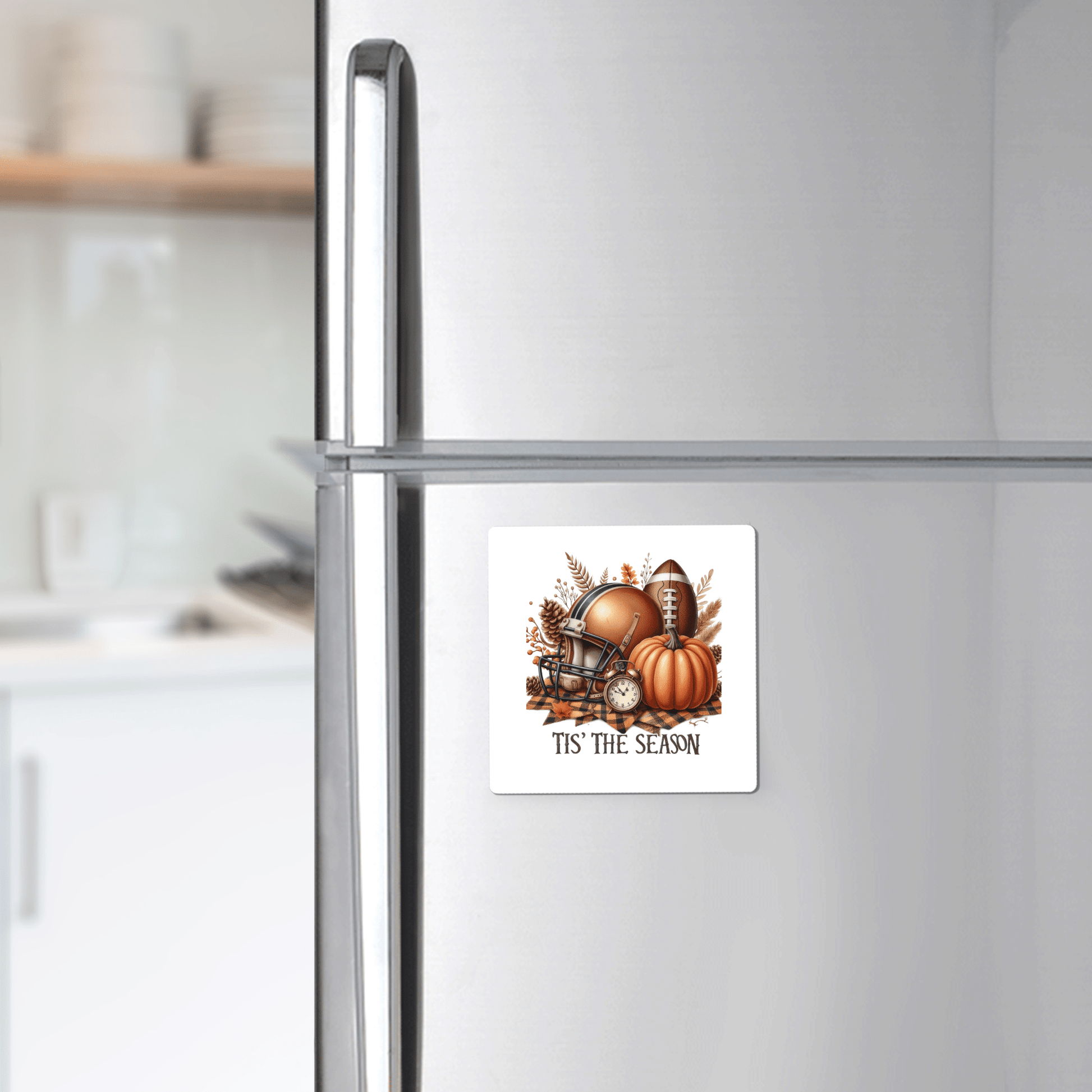 The Tis’ the Season Magnet by Mirabilia Boutique features a football, autumn leaves, helmet, and pumpkins—perfect fall football pumpkin decor for your fridge.