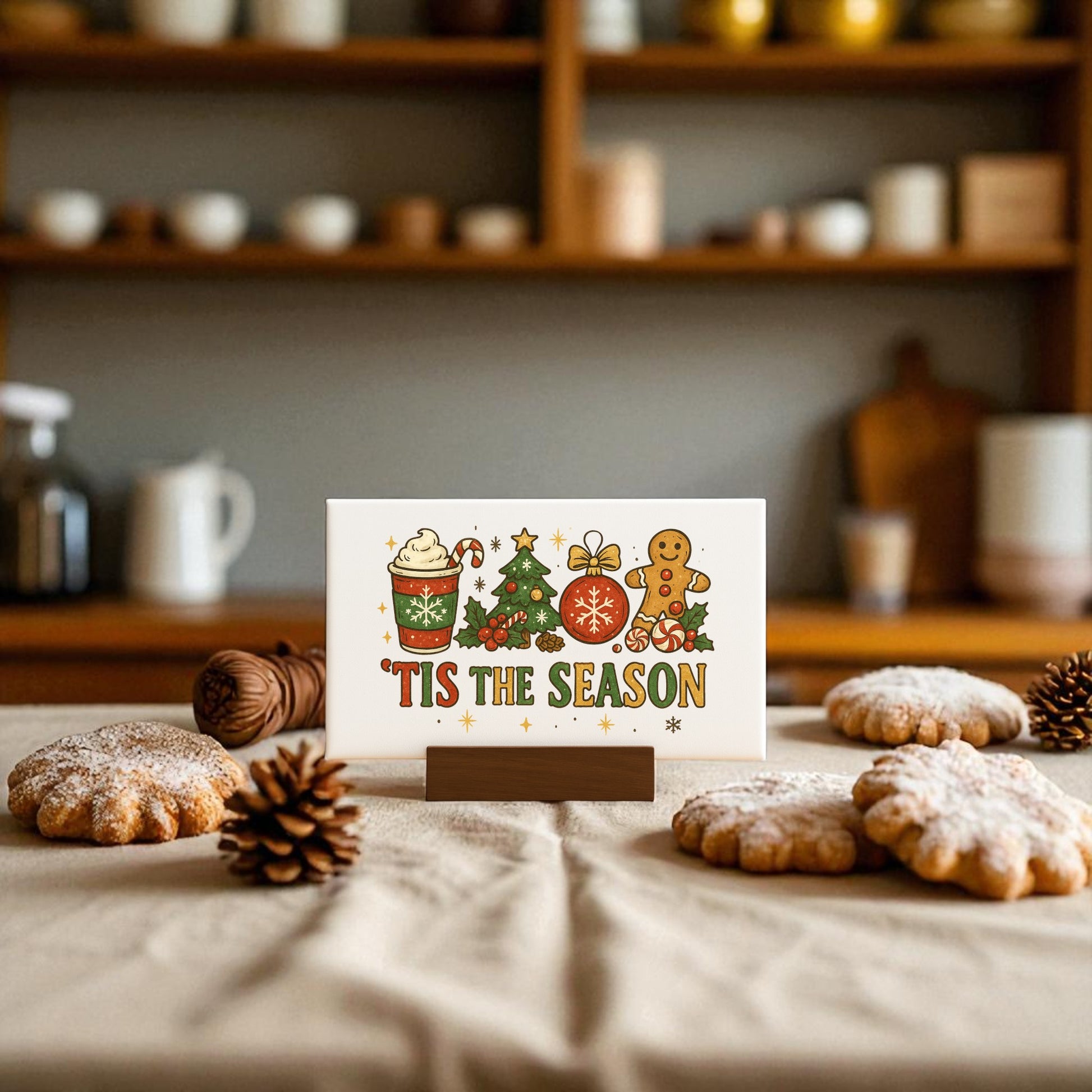 The 'Tis the Season Mini Canvas (6x4") by Mirabilia Boutique features festive art and comes with a base—perfect Christmas decor or a holiday gift for your kitchen table alongside cookies and pinecones.