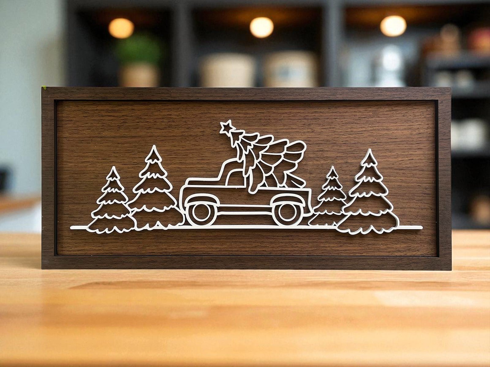 The Mirabilia Boutique Truck & Tree Laser Cut Christmas Sign (18x8) features a minimalist truck with a Christmas tree, pine accents, and rustic style—perfect festive wall art for your holiday decor.