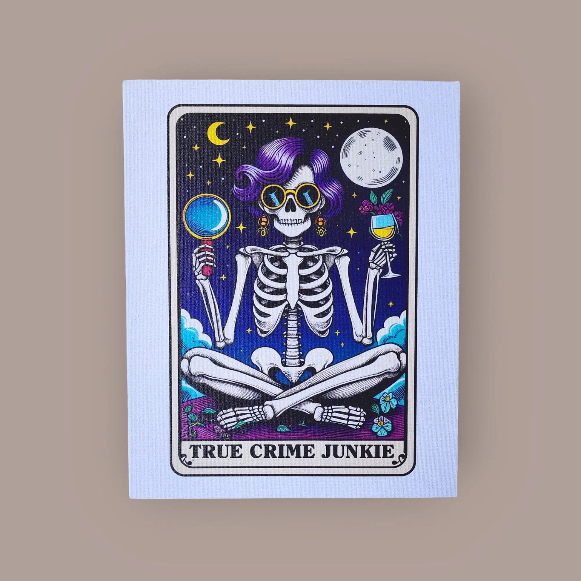 A vibrant illustration of a skeleton with purple hair, donning yellow sunglasses and earrings, and holding a magnifying glass and wine glass while sitting cross-legged. The backdrop depicts a night sky adorned with the moon and stars. The text "TRUE CRIME JUNKIE" is displayed at the bottom. This piece makes for perfect True Crime decor as an 8x10 Canvas Sign from Mirabilia Boutique, named "True Crime Junkie Funny 8x10 Canvas Sign.