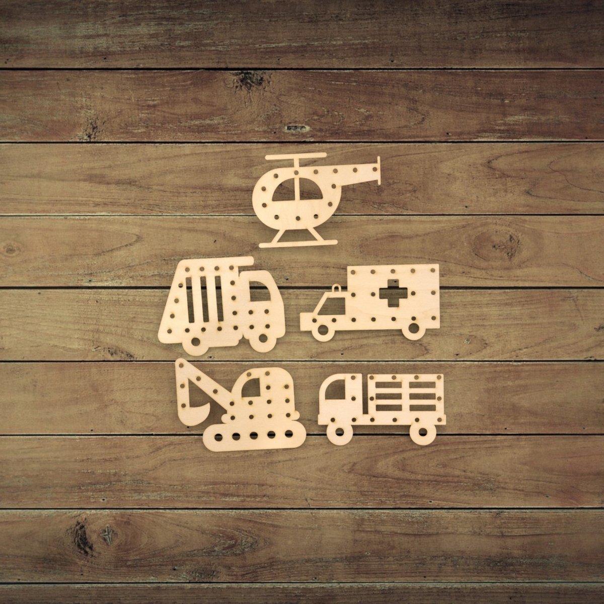 Five wooden cutouts—a helicopter, garbage truck, ambulance, excavator, and fire truck—from Mirabilia Boutique’s Vehicle Lacing Trays for Fine Motor Skills are displayed on a rustic surface, ideal for developing fine motor skills.