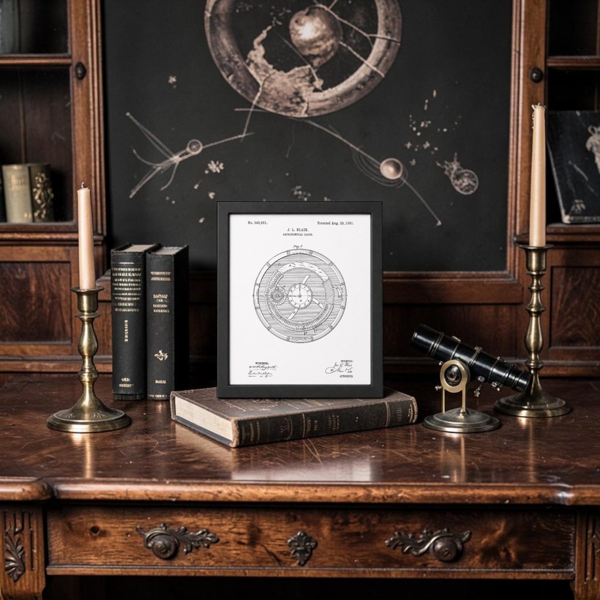 A vintage wooden desk with books, brass candlesticks, a telescope, and a framed Astronomical Clock Patent Art Print by Mirabilia Boutique. Behind the desk is a chalkboard with astronomical drawings, evoking an antique, scholarly atmosphere.