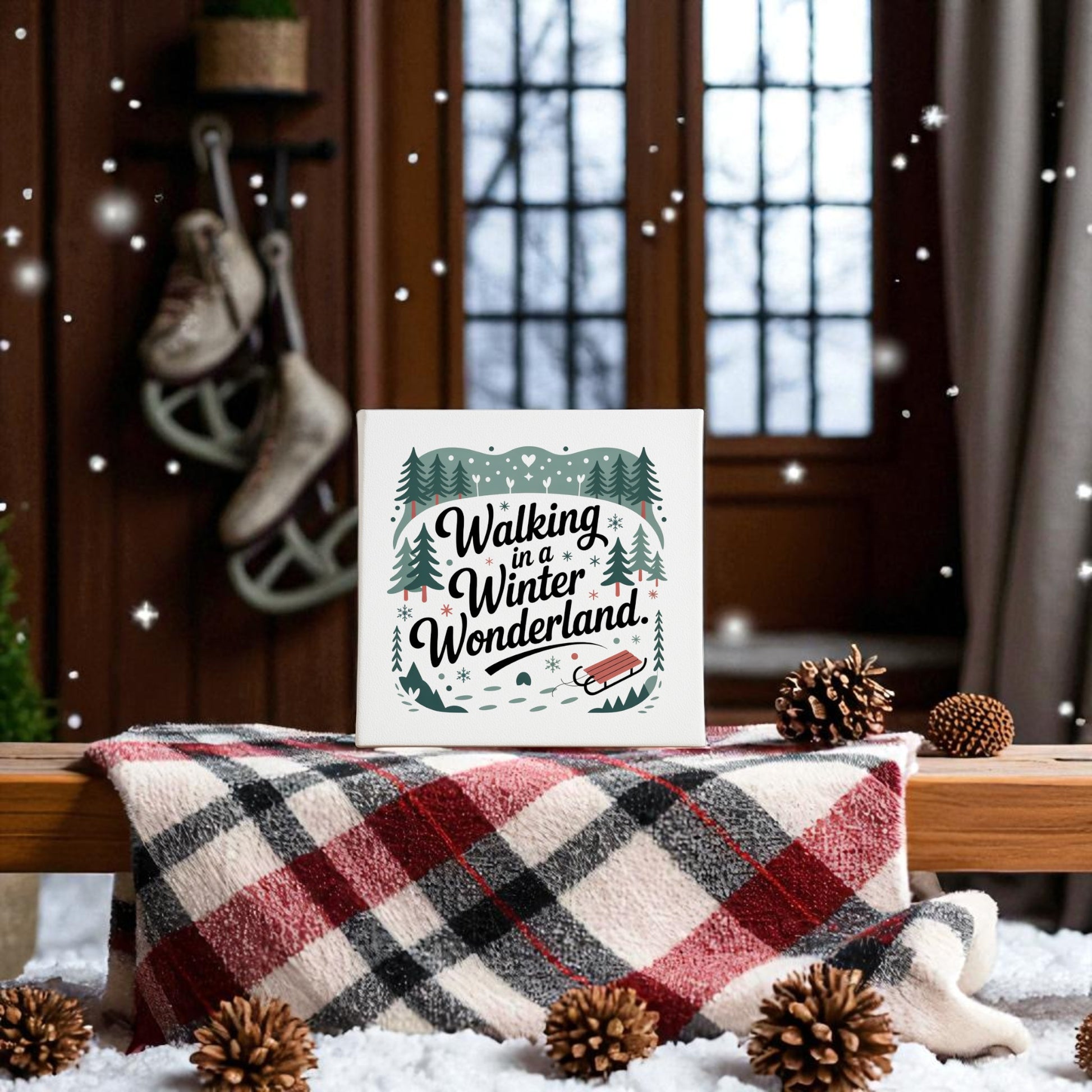 Create a cozy winter vibe with the "Winter Wonderland Canvas | 8x8 Holiday Decor" by Mirabilia Boutique, featuring festive art perfect for holiday walls—shown atop a plaid blanket with pinecones, snow, and ice skates by a snowy window.