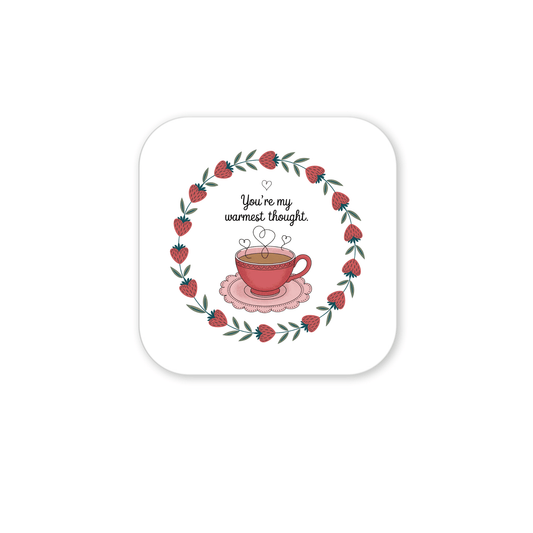 The Warmest Thought Tea Cup Magnet by Mirabilia Boutique features a red teacup with heart-shaped steam on a pink saucer, surrounded by red berries and green leaves. Caption: "You're my warmest thought." The perfect best friend gift!.