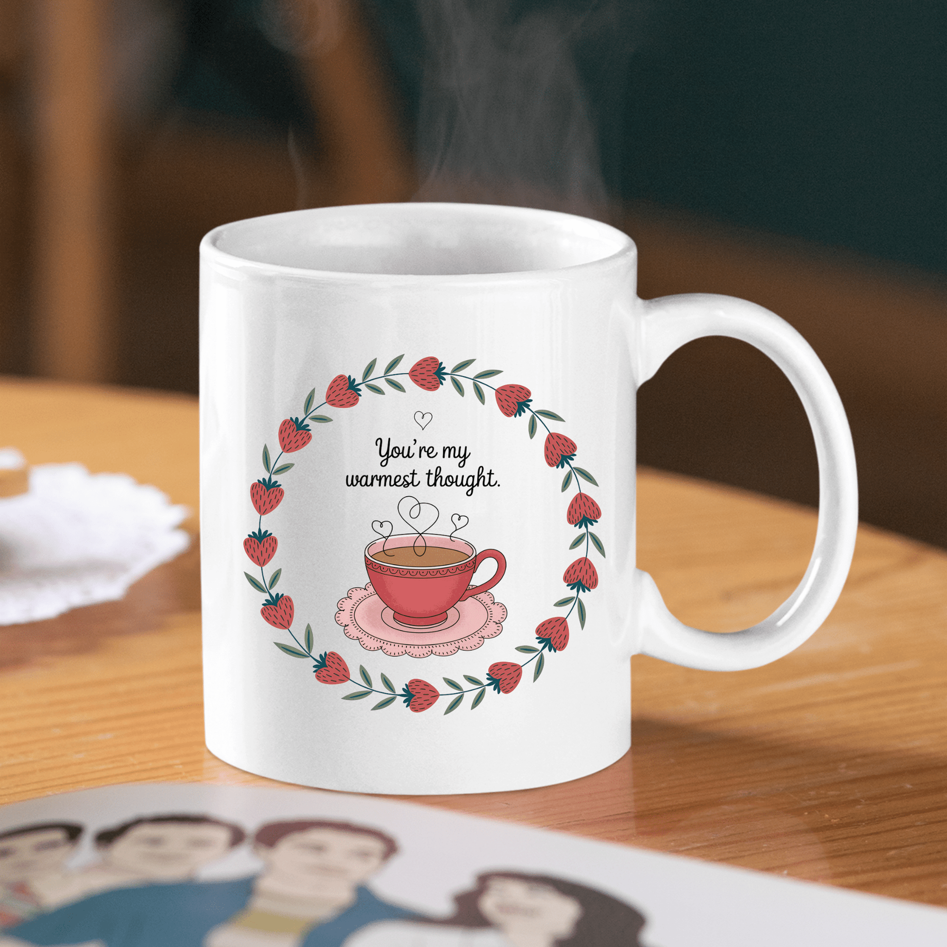 The Warmest Thought Mug – Sweet Teacup Gift Mug by Mirabilia Boutique features strawberry blossoms, a leaf border, and a steaming teacup with “You’re my warmest thought.” This ceramic mug is perfect for heartfelt moments.