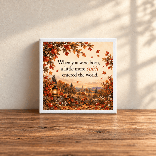 A Little More Spirit Nursery Keepsake Canvas by Mirabilia Boutique features autumn scenery and flowers on a wooden table, with sunlight casting shadows on the wall behind.