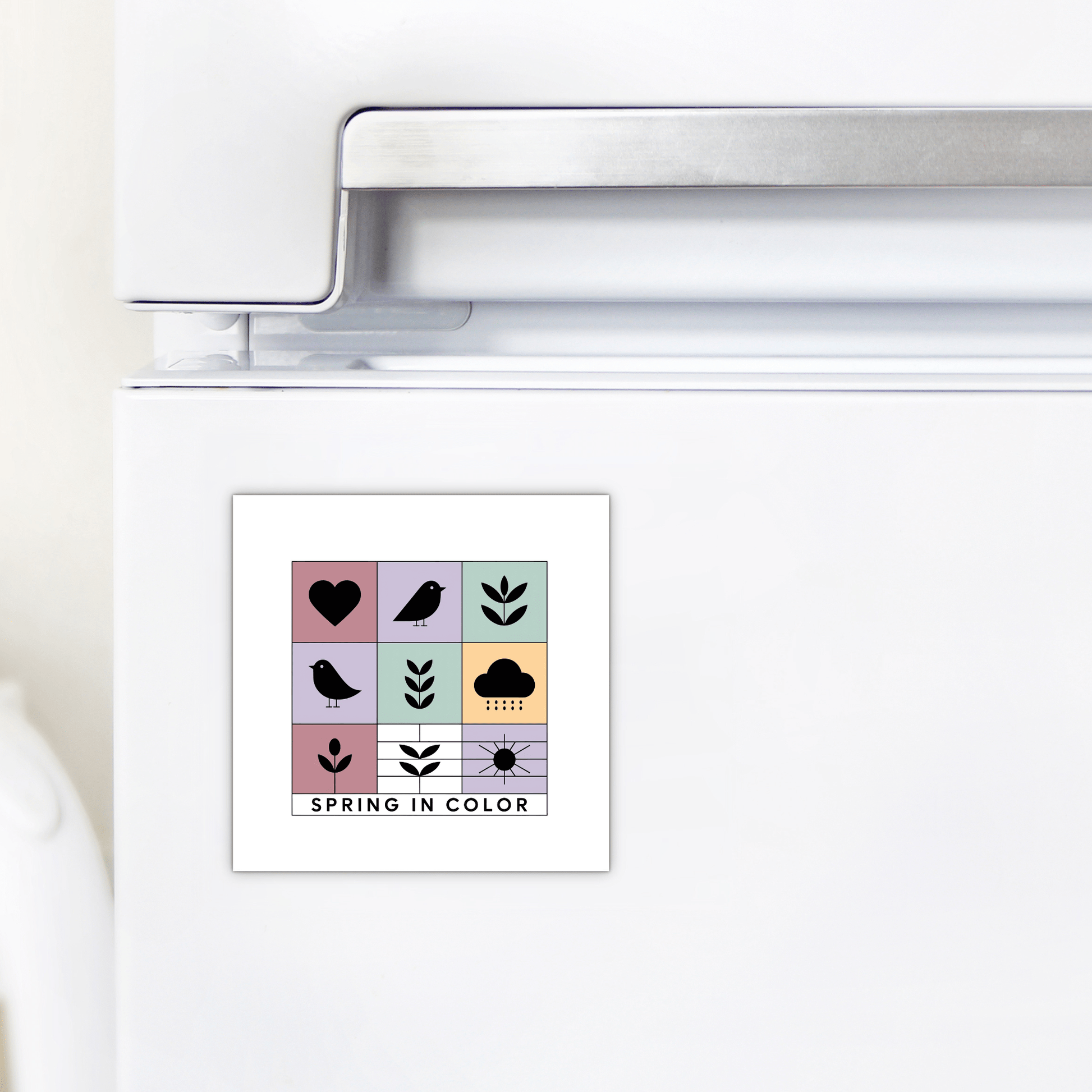 The Mirabilia Boutique Spring in Color Magnet – Whimsical Pastel Icons features pastel blocks with heart, bird, leaf, and flower icons plus "SPRING IN COLOR" text, making it a charming seasonal gift for any refrigerator.