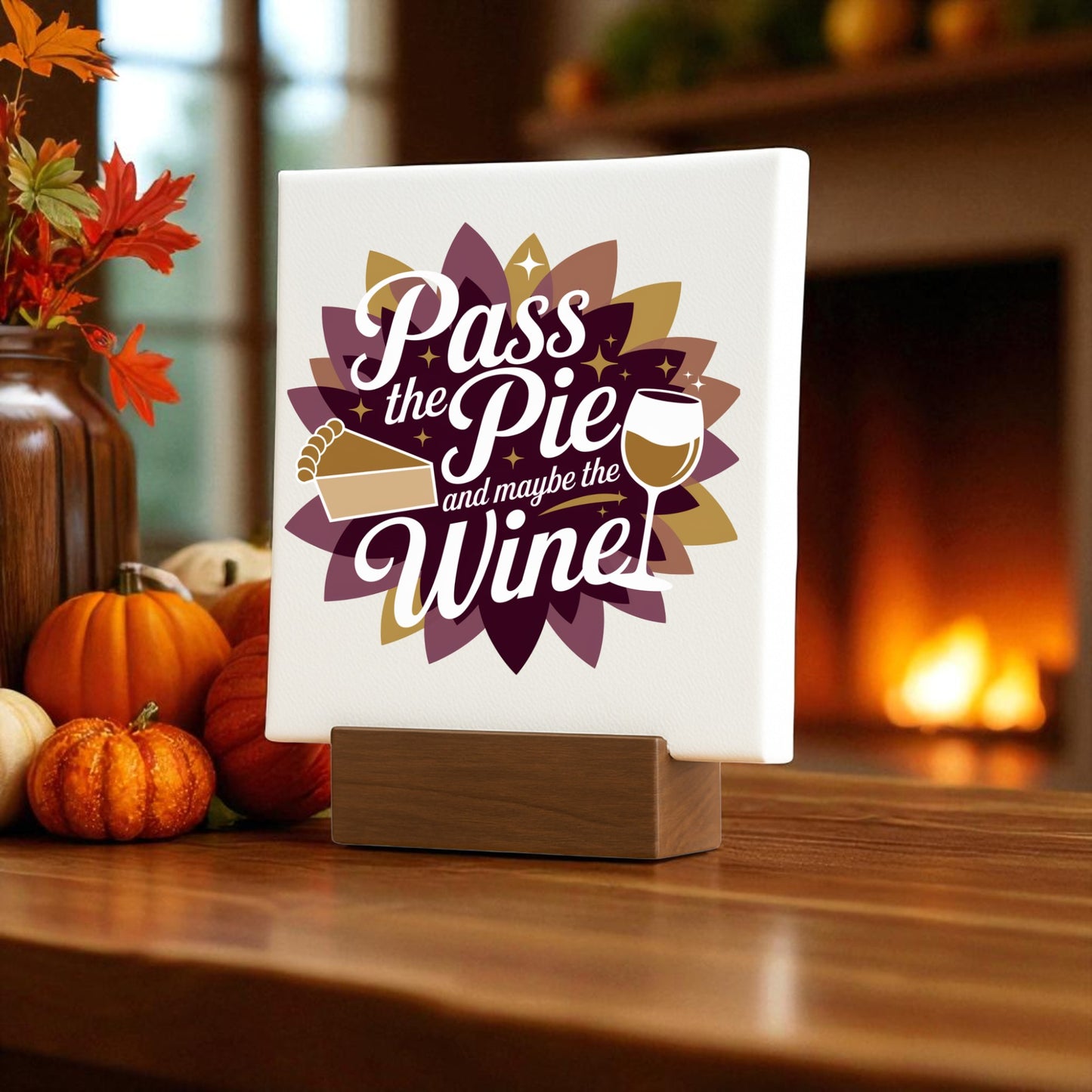 The Mirabilia Boutique "Pass the Pie and Maybe the Wine" Mini Fall Sign adds festive Thanksgiving decor beside autumn pumpkins and leaves, making it a charming wine lover gift for any cozy home.