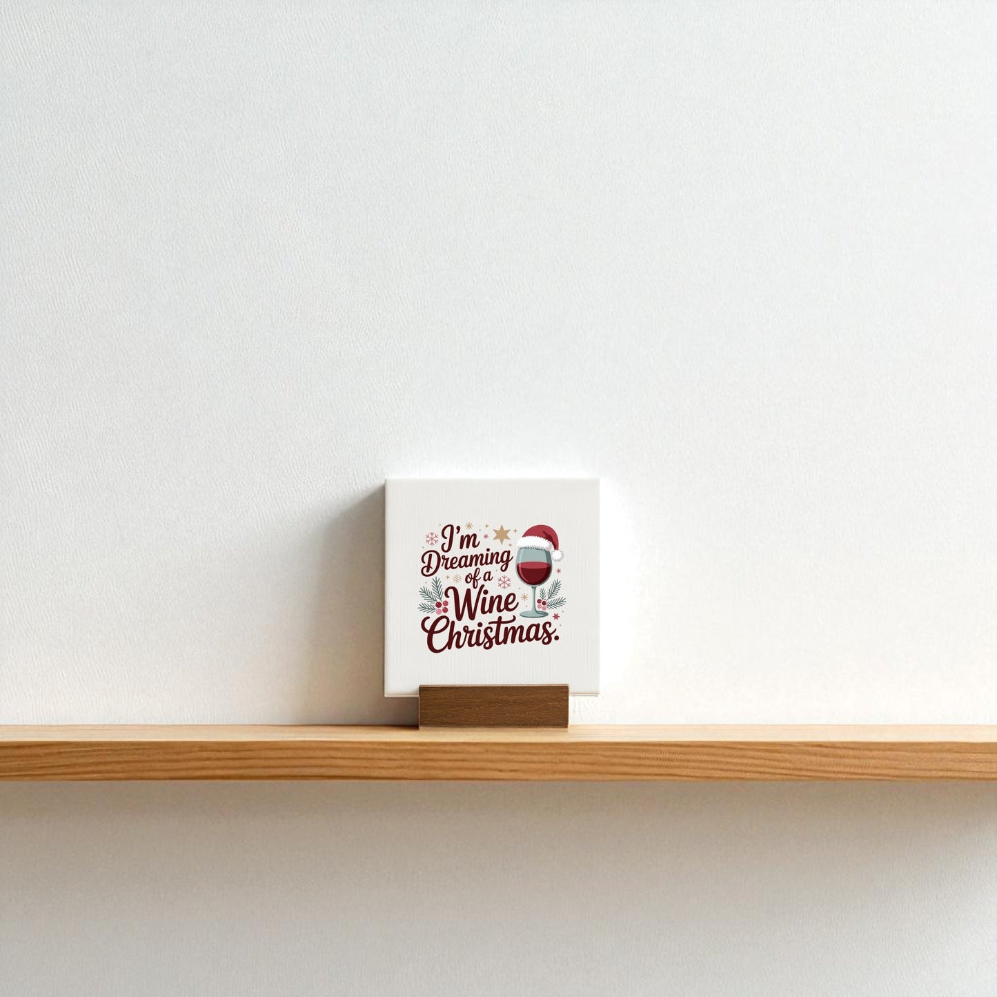 The Mirabilia Boutique Wine Christmas Mini Canvas sits on its base, featuring a festive wine glass and Santa hat with the phrase “I’m dreaming of a wine Christmas”—a perfect, funny holiday sign for any wine lover’s décor.