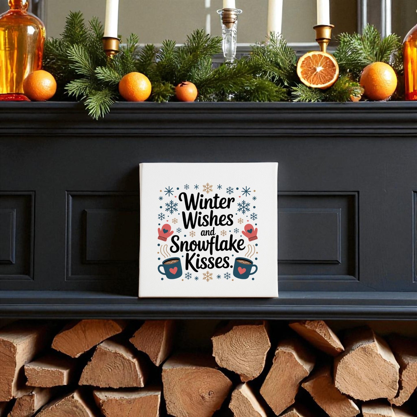 A festive mantle with candles, oranges, and greenery showcases the Mirabilia Boutique "Winter Wishes Canvas Sign | Holiday Home Decor 8x8" above firewood—perfect for adding seasonal charm to your home.