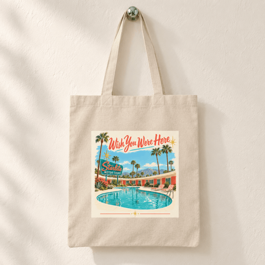 Wish You Were Here Tote | Chrome & Starlight canvas bag featuring a mid-century postcard illustration of a motel pool with a “Starlite Motor Court” sign and the text “Wish You Were Here.”.