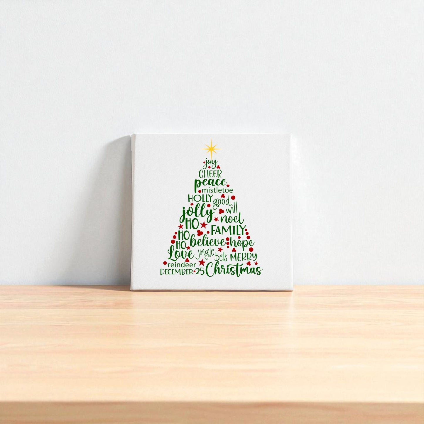 The Word Art Christmas Tree Canvas by Mirabilia Boutique features festive words in red and green forming a tree with a yellow star, adding holiday charm to your space. Available as 8x8 holiday decor, it's perfect for brightening up any room.