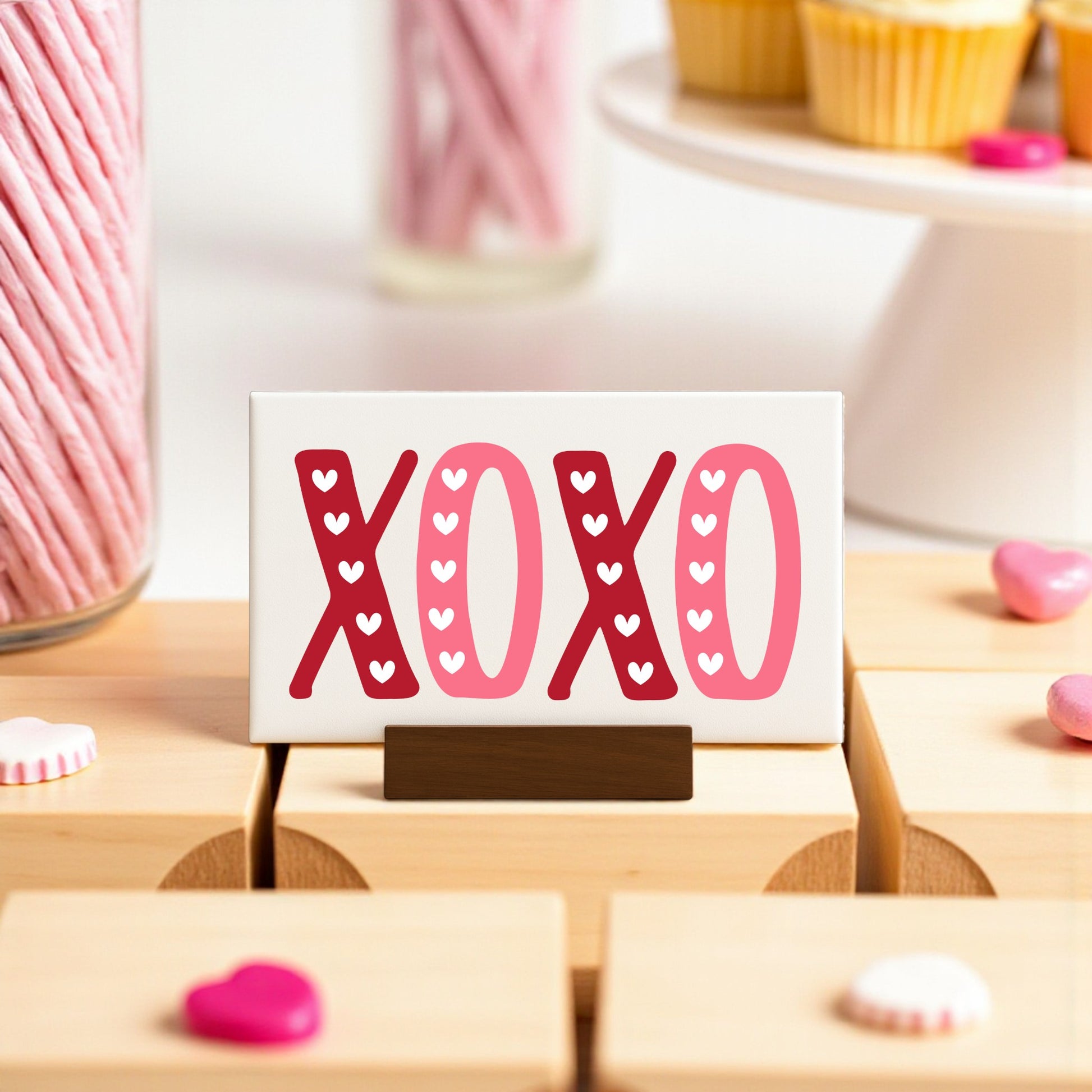 Surprise your Valentine with the Mirabilia Boutique XOXO Valentine's Sign—a 6x4 canvas in red and pink on a wood base. Complete your decor with sweet treats for a charming celebration.