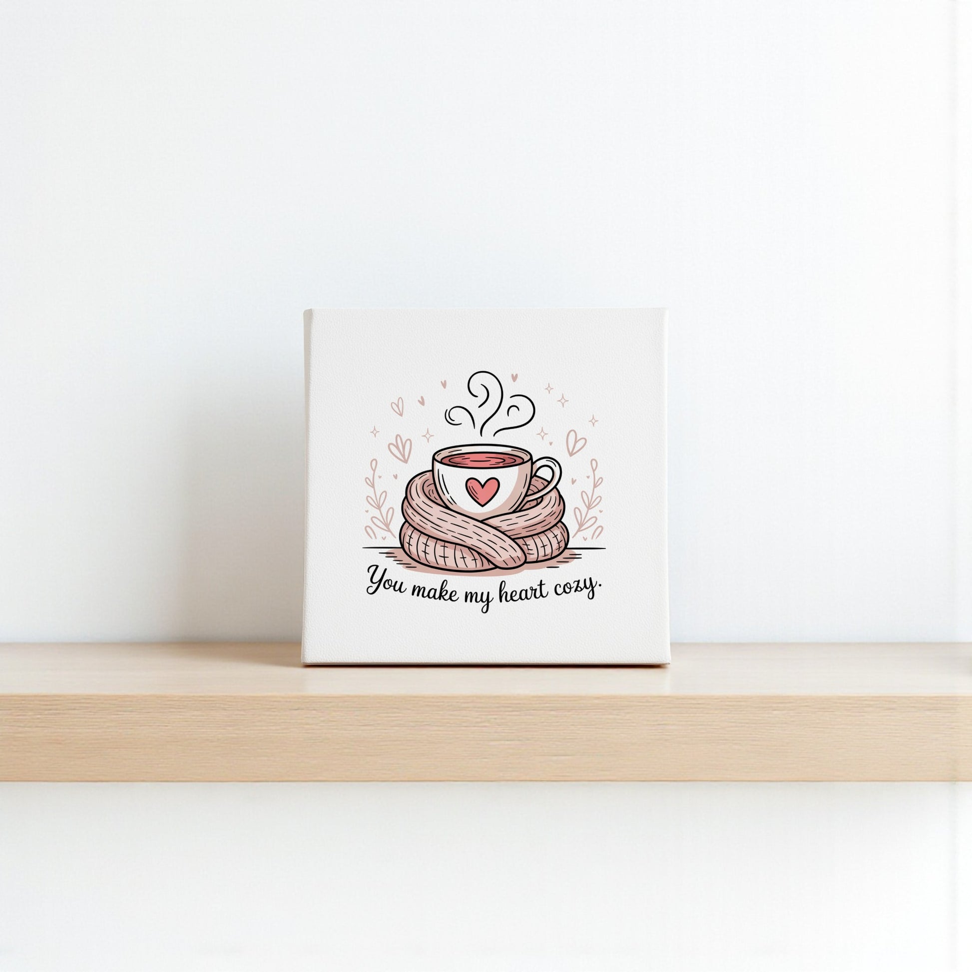 The Mirabilia Boutique "You Make My Heart Cozy Canvas" features a steaming cup with a heart and scarf, plus the sweet phrase—ideal as a warm Valentine’s gift or romantic coffee decor for any space.