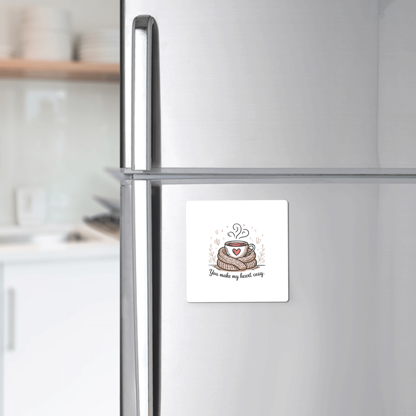 A silver fridge features Mirabilia Boutique's Cozy Heart Magnet—a romantic square magnet with a cake, heart, and "You make my heart cozy"—adding a charming gift touch to this modern kitchen.