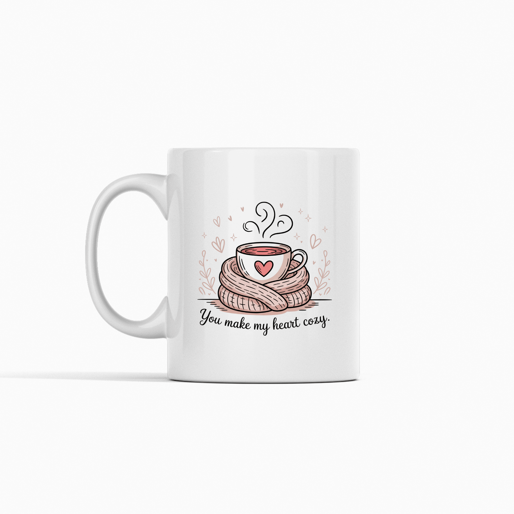 The You Make My Heart Cozy Mug by Mirabilia Boutique features a steaming cup wrapped in a scarf with hearts and the phrase "You make my heart cozy"—a cute coffee lover gift, perfect for Valentine’s Day.